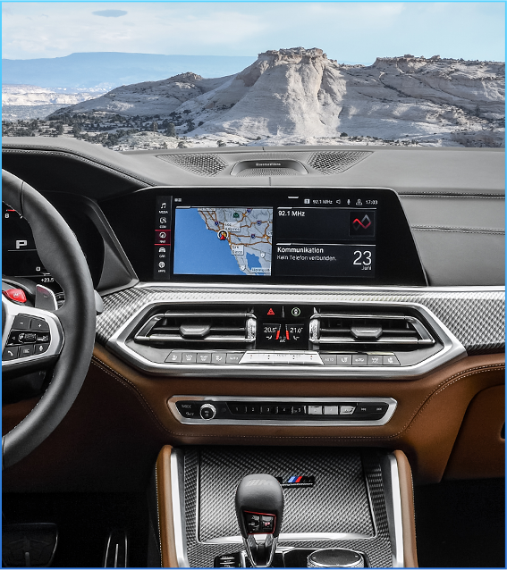 BMW car dashboard with built-in navigation system and infotainment display showing GPS map and driving information