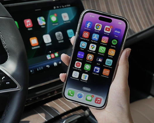 iPhone connected to car display via Ottocast wireless CarPlay adapter showing app icons for seamless in-car entertainment